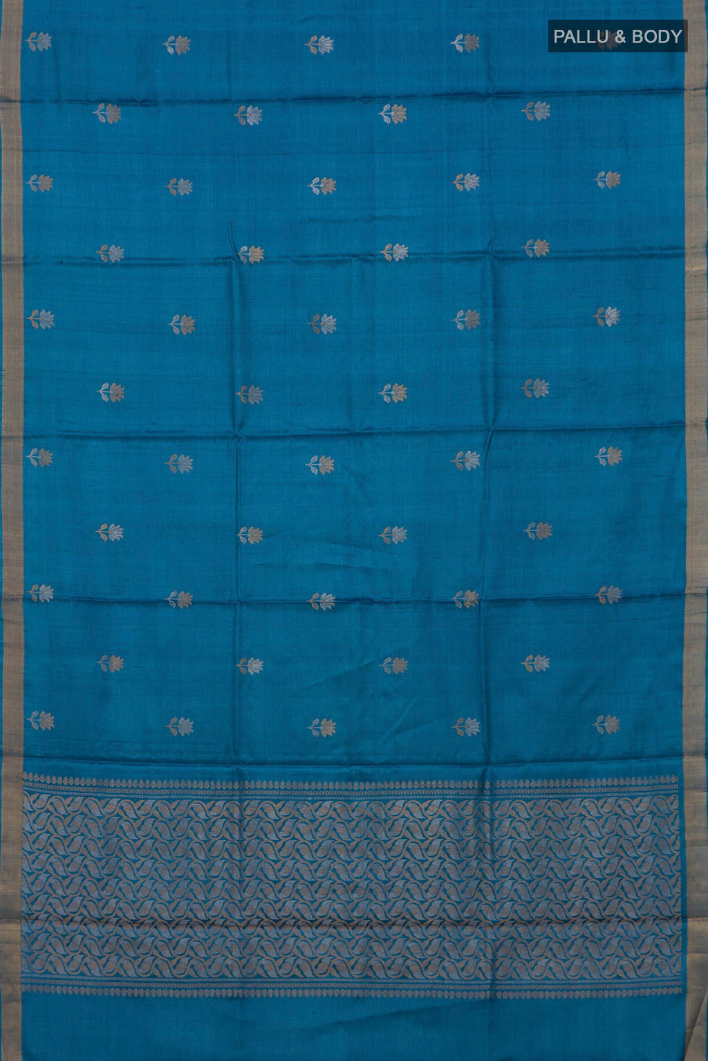 Flat view of Blue Tussar Saree with Zari Butta on the body and Zari Border. 