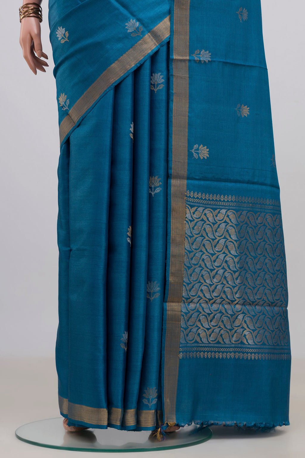 Pleats and pallu of Blue Tussar Saree with Zari Butta on the body and Zari Border. 