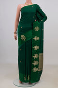 Pure Silk Bottle Green Banarasi Katan Saree with Zari Butta on the body and Fancy Border.  displayed on a mannequin