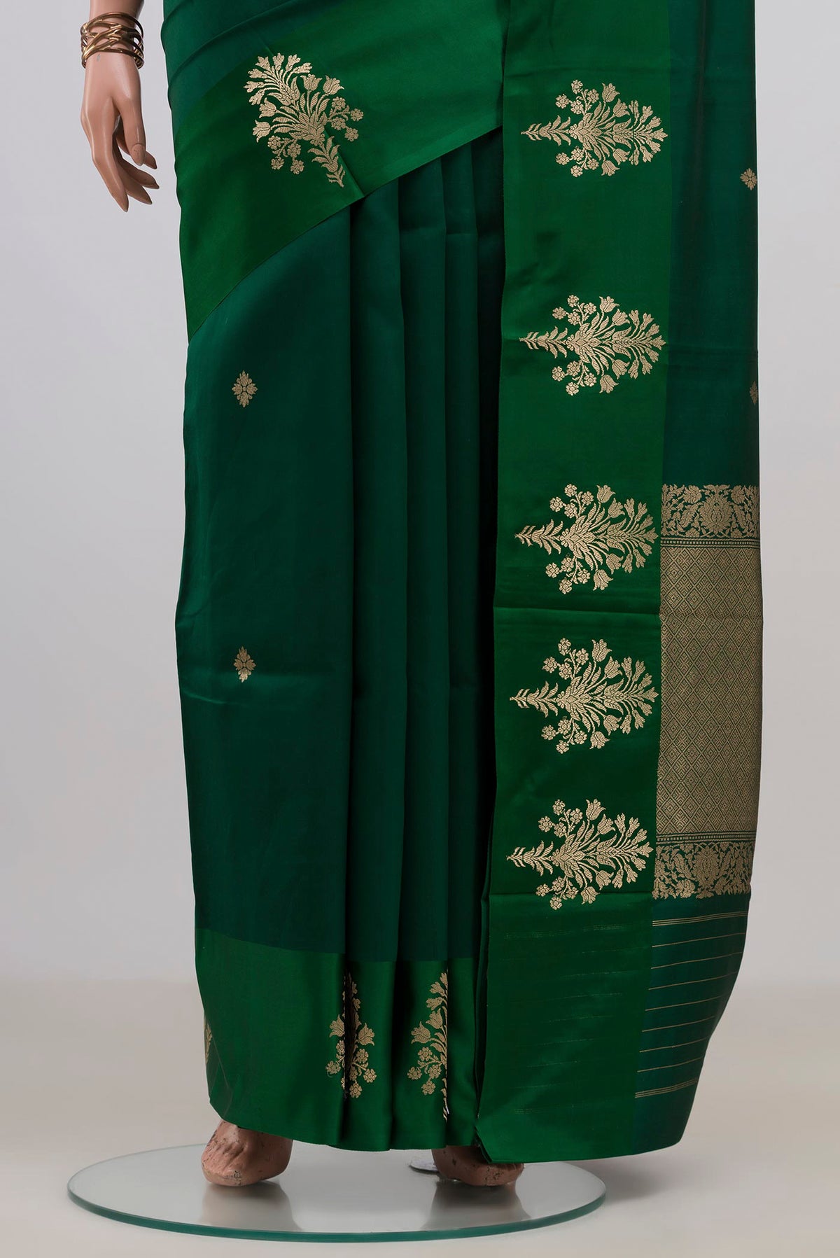 Pleats and pallu of Pure Silk Bottle Green Banarasi Katan Saree with Zari Butta on the body and Fancy Border. 