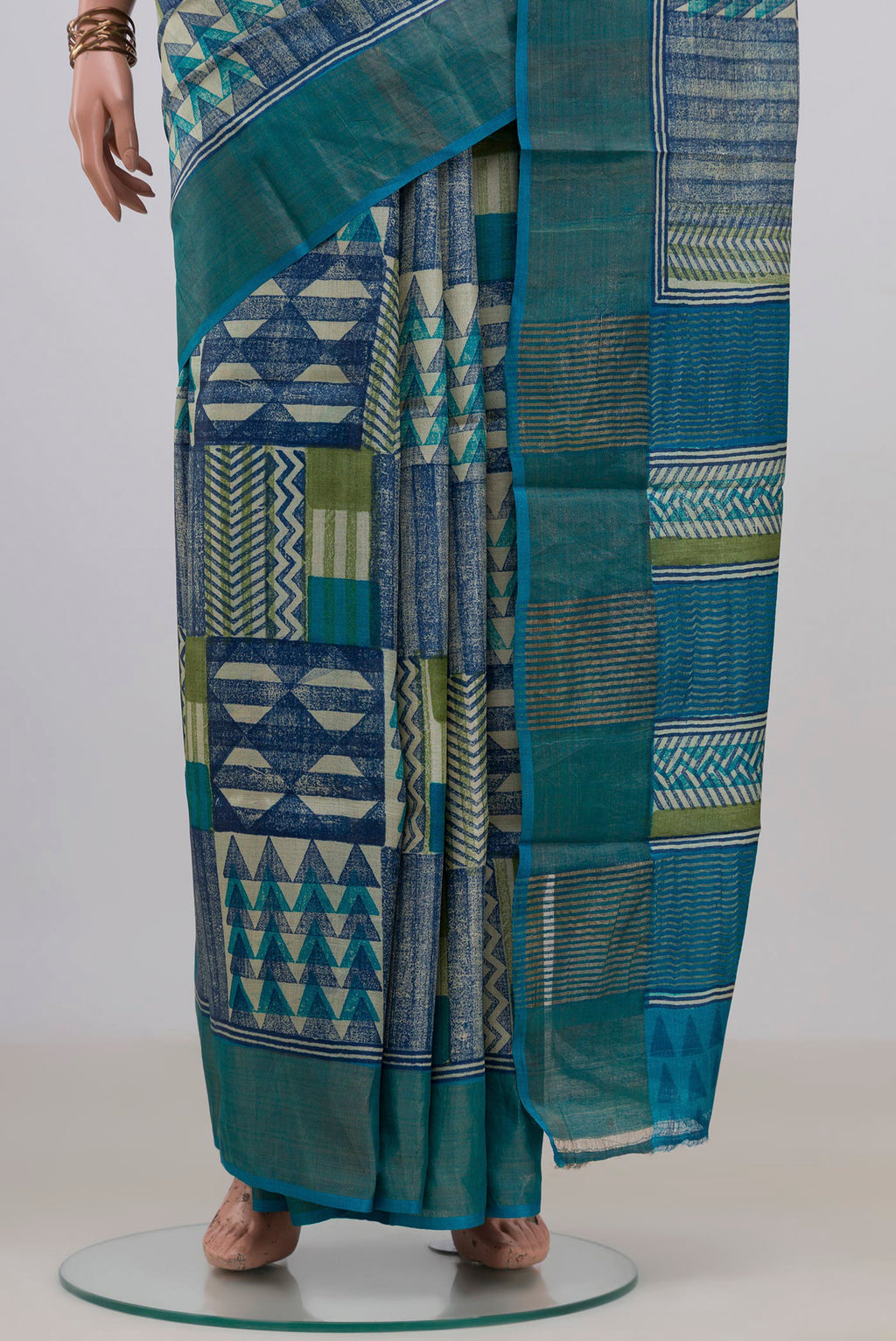 Pleats and pallu of Multi Color Tussar Saree with Printed design on the body and Zari Border. 