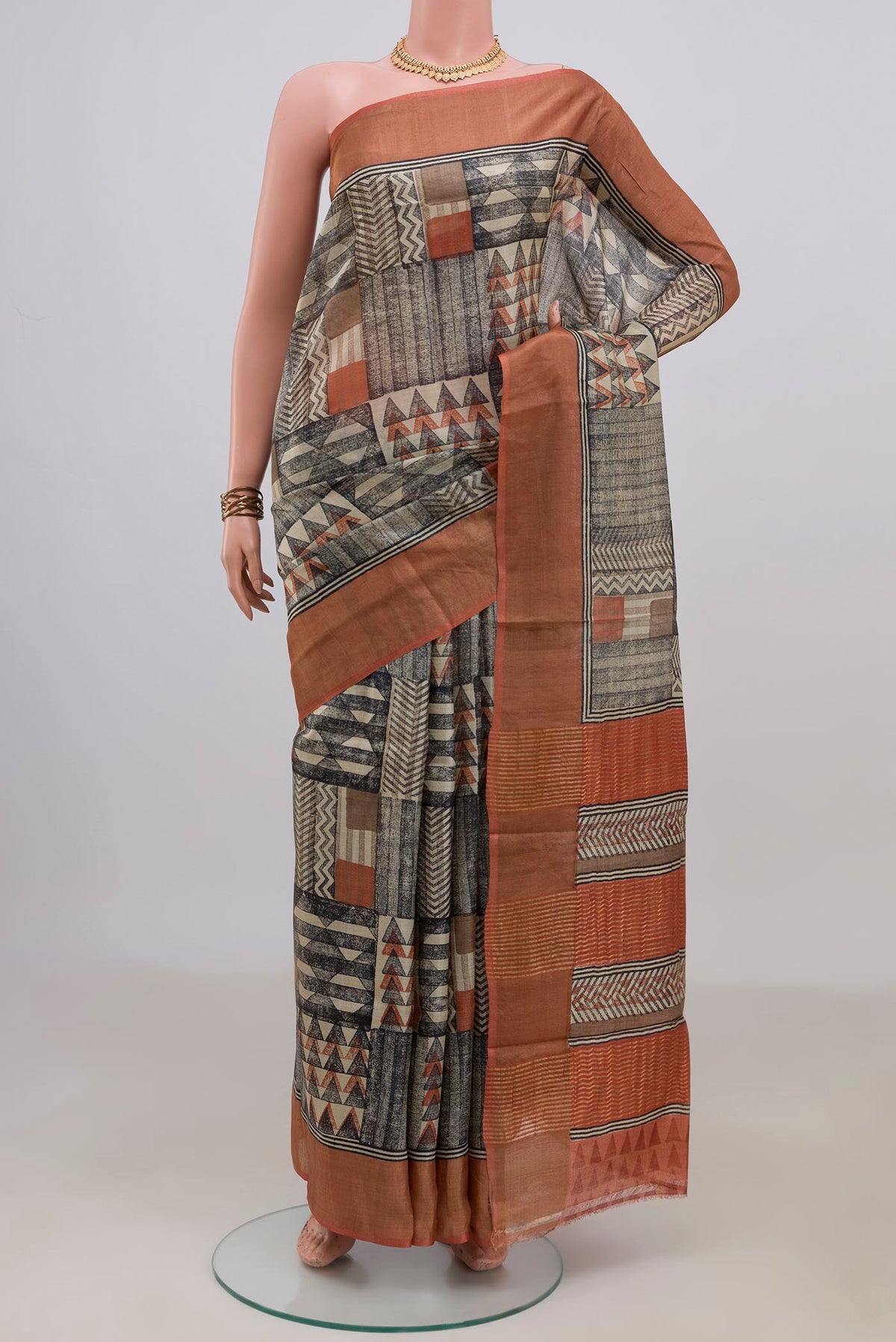 Multi Color Tussar Saree with Printed design on the body and Zari Border.  displayed on a mannequin