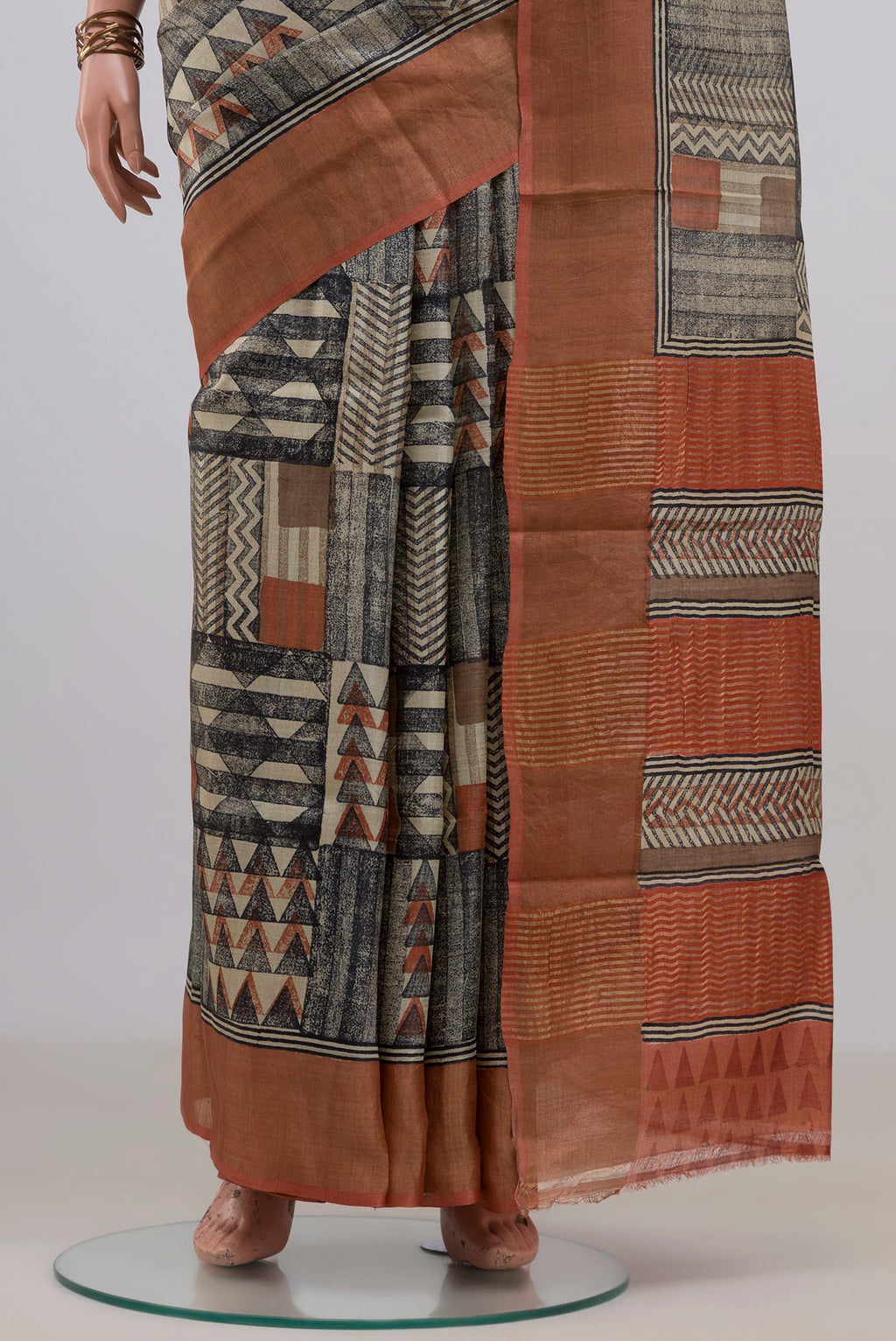 Pleats and pallu of Multi Color Tussar Saree with Printed design on the body and Zari Border. 