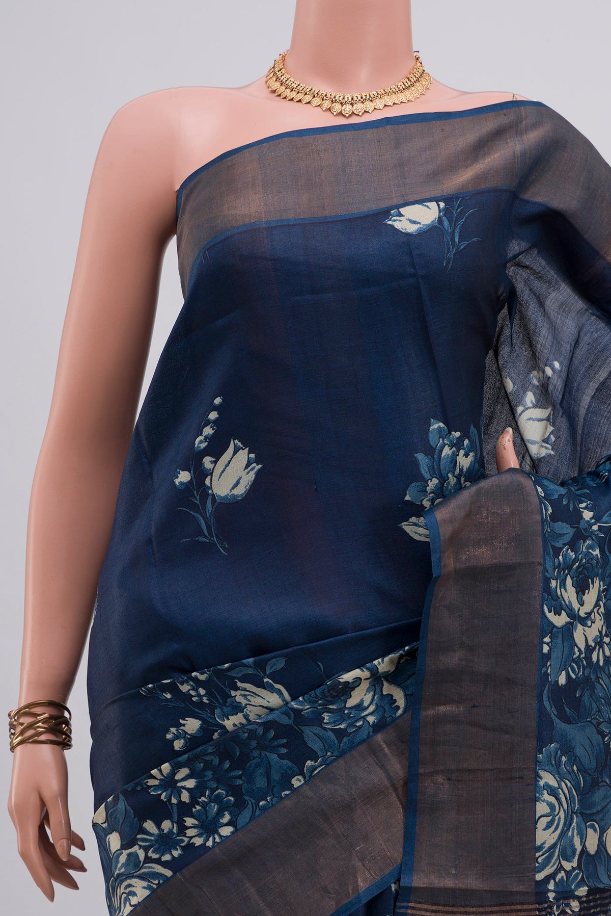 Border image of Pure Silk Blue Tussar Saree with Printed design on the body and Zari Border. 
