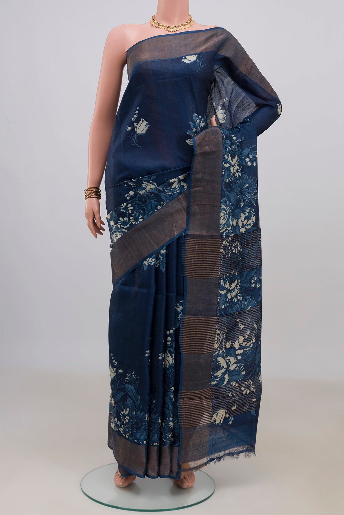 Pure Silk Blue Tussar Saree with Printed design on the body and Zari Border.  displayed on a mannequin