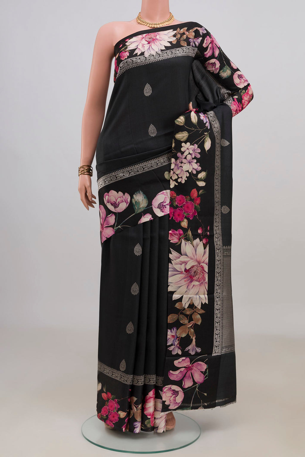 Black Tussar Saree with Zari Butta on the body and Fancy Border.  displayed on a mannequin