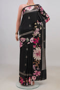 Black Tussar Saree with Zari Butta on the body and Fancy Border.  displayed on a mannequin