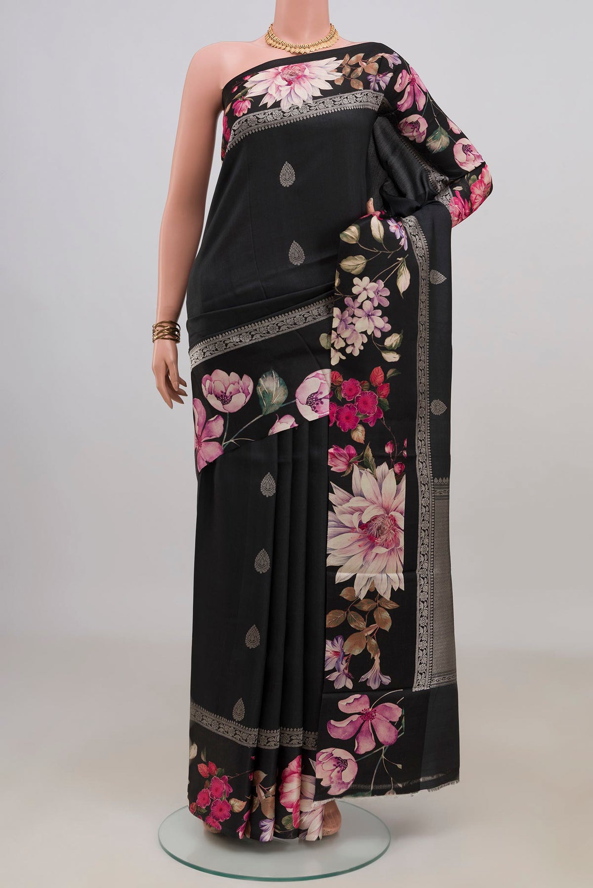 Black Tussar Saree with Zari Butta on the body and Fancy Border.  displayed on a mannequin
