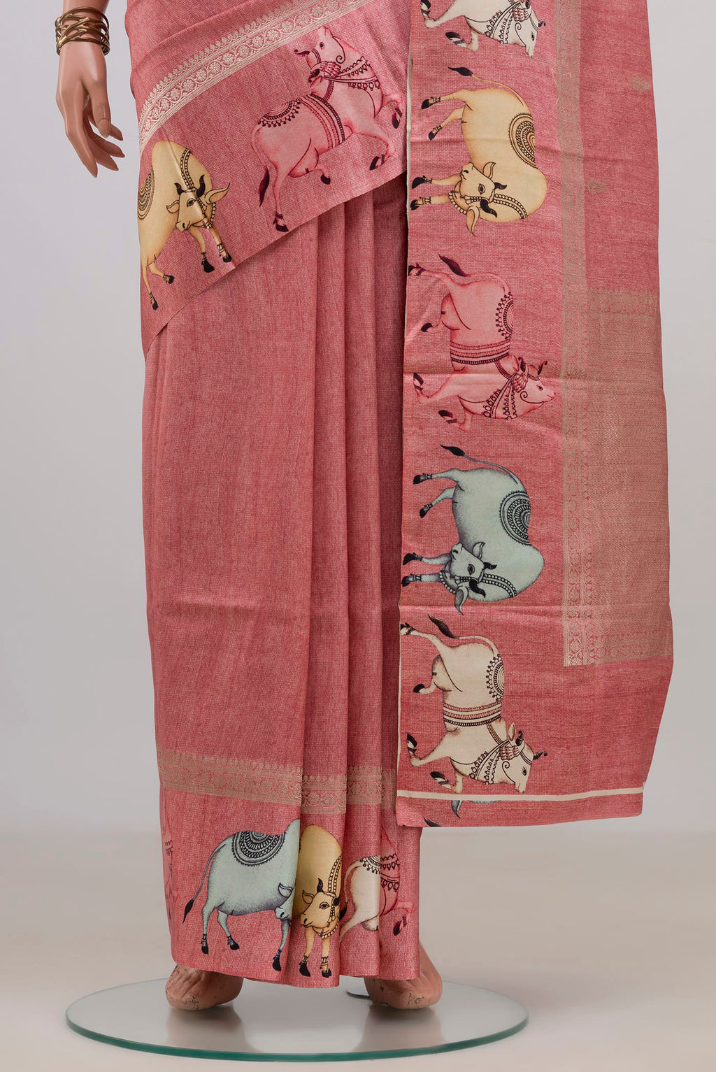 Pleats and pallu of Peach Tussar Saree with Zari Butta on the body and Fancy Border. 