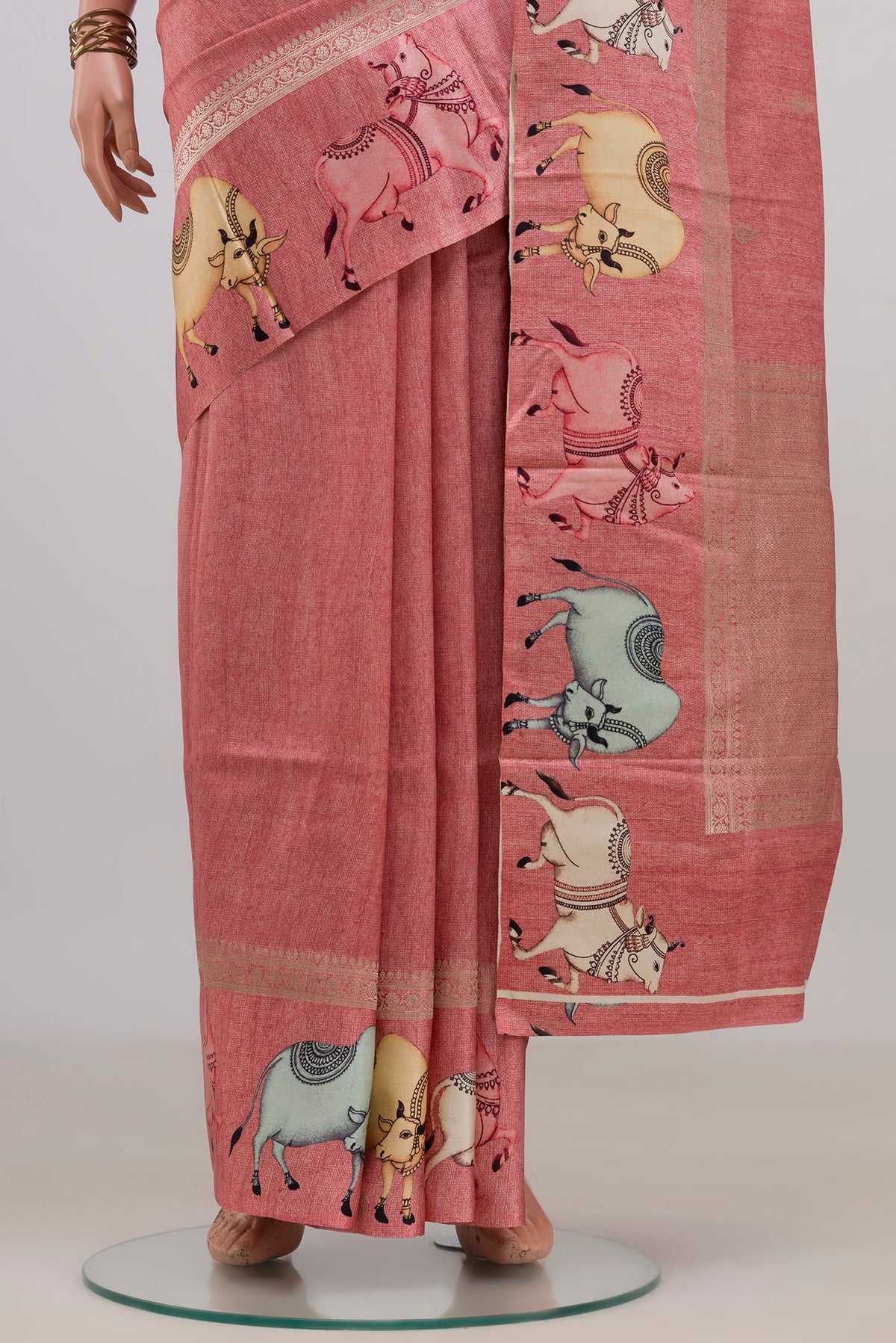 Pleats and pallu of Peach Tussar Saree with Zari Butta on the body and Fancy Border. 