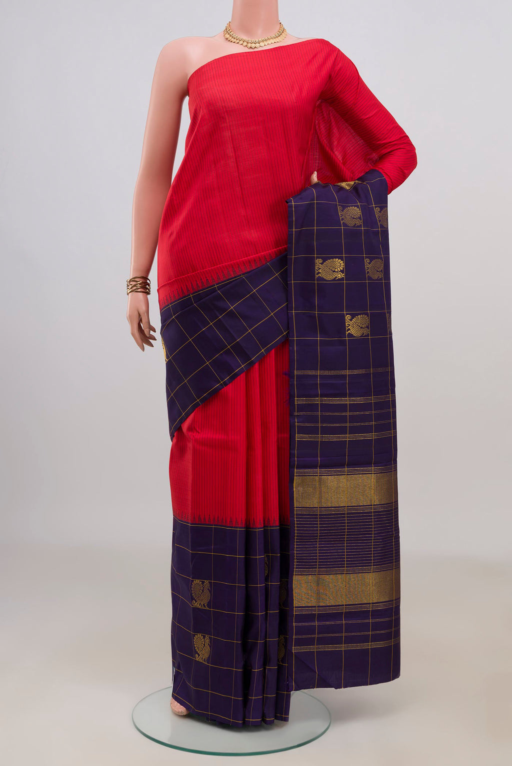 Pure Silk Red Kanjivaram Saree with Stripes on the body and Checks Border.  displayed on a mannequin