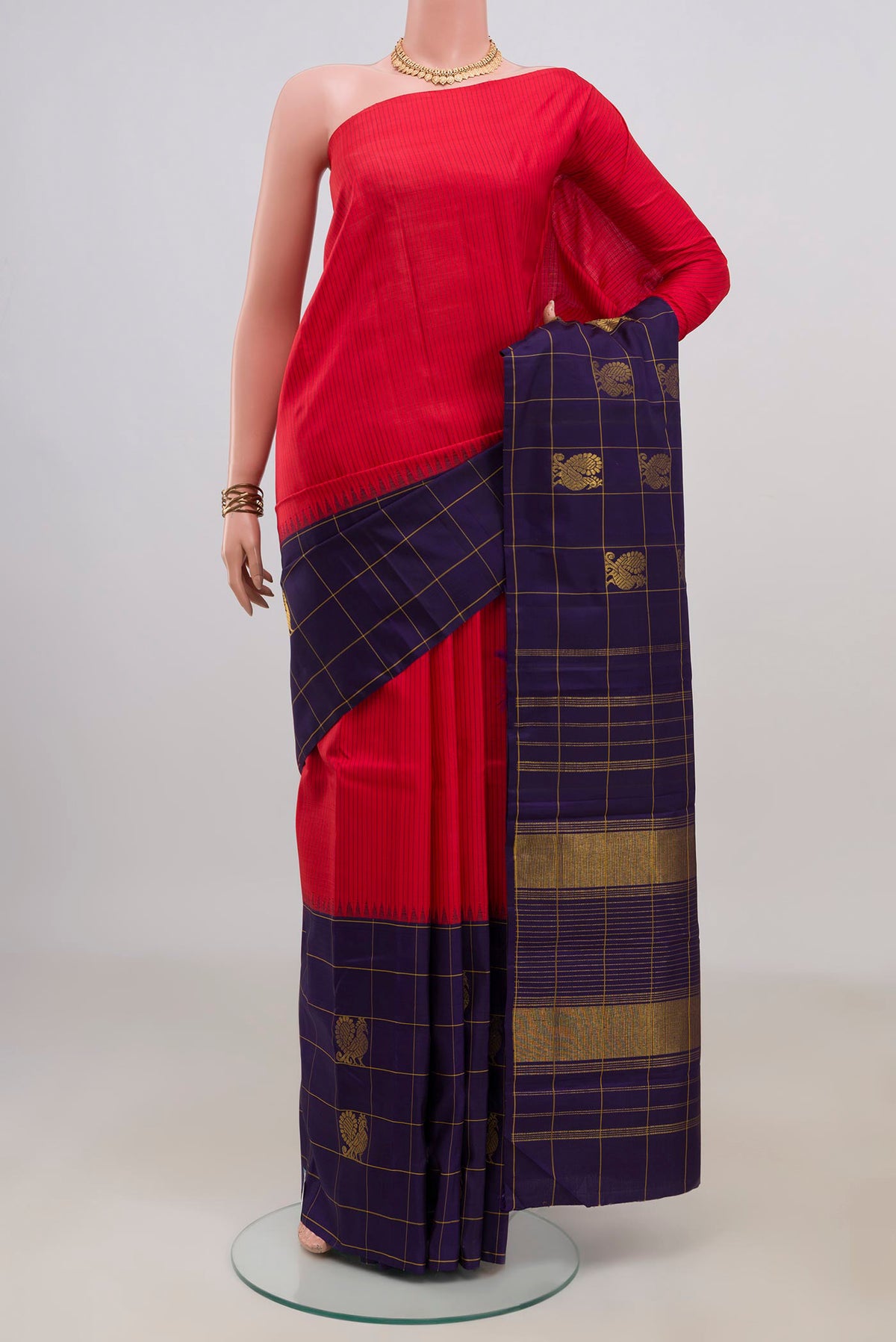 Pure Silk Red Kanjivaram Saree with Stripes on the body and Checks Border.  displayed on a mannequin