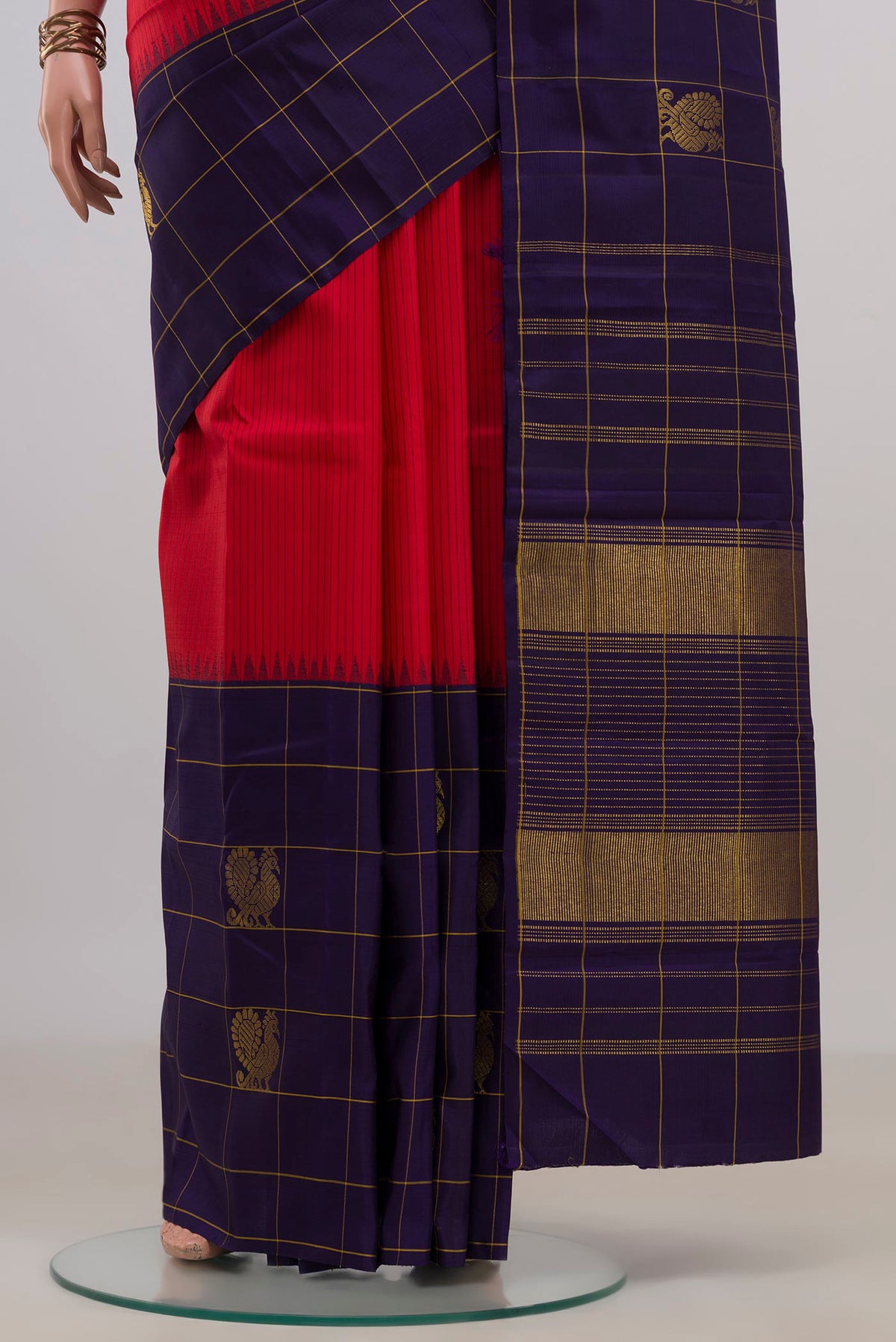 Pleats and pallu of Pure Silk Red Kanjivaram Saree with Stripes on the body and Checks Border. 