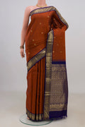 Pure Silk Rust Kanjivaram Saree with Zari Butta on the body and Zari Border.  displayed on a mannequin