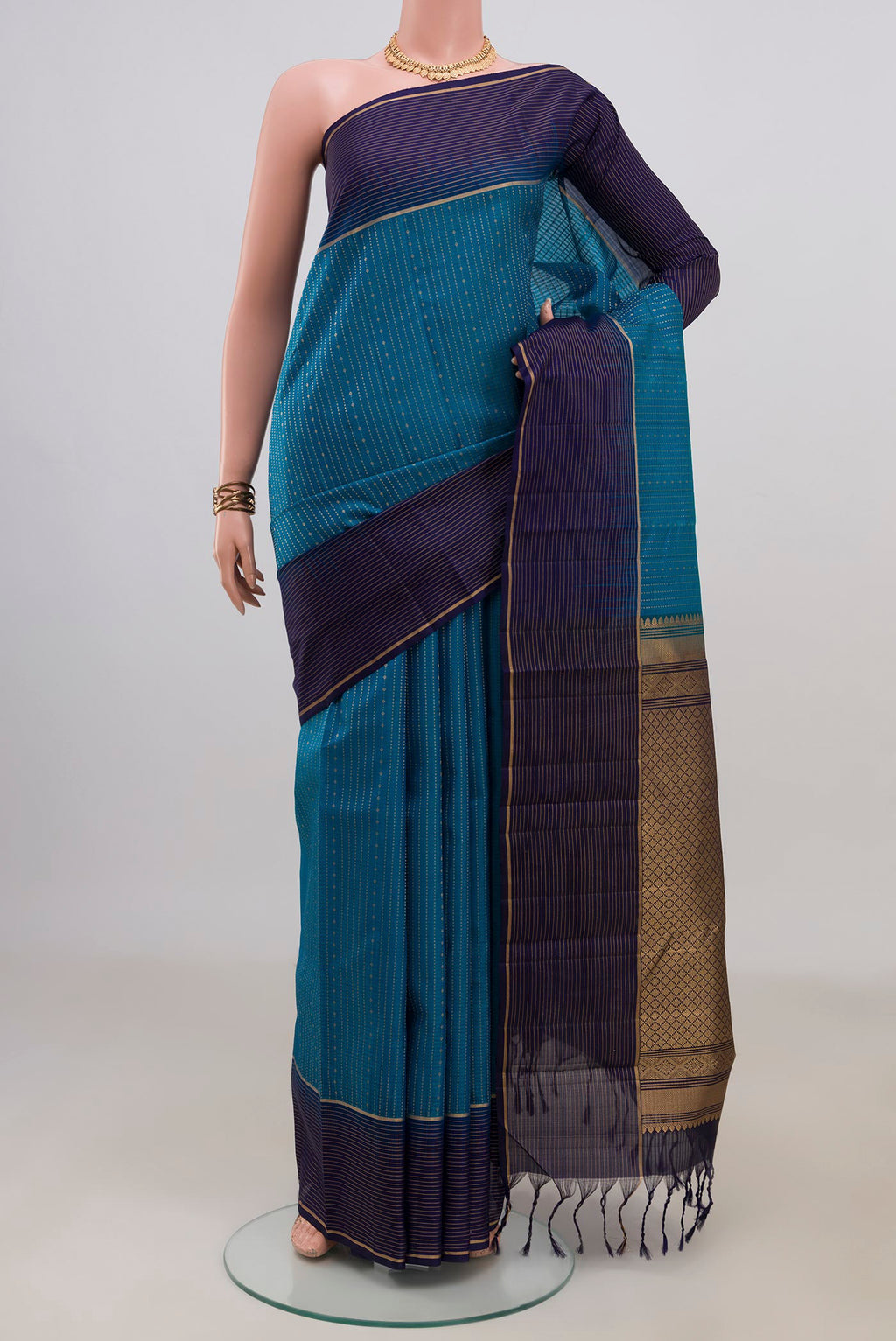 Pure Silk Light Blue Kanjivaram Saree with Stripes on the body and Thin Zari Line.  displayed on a mannequin