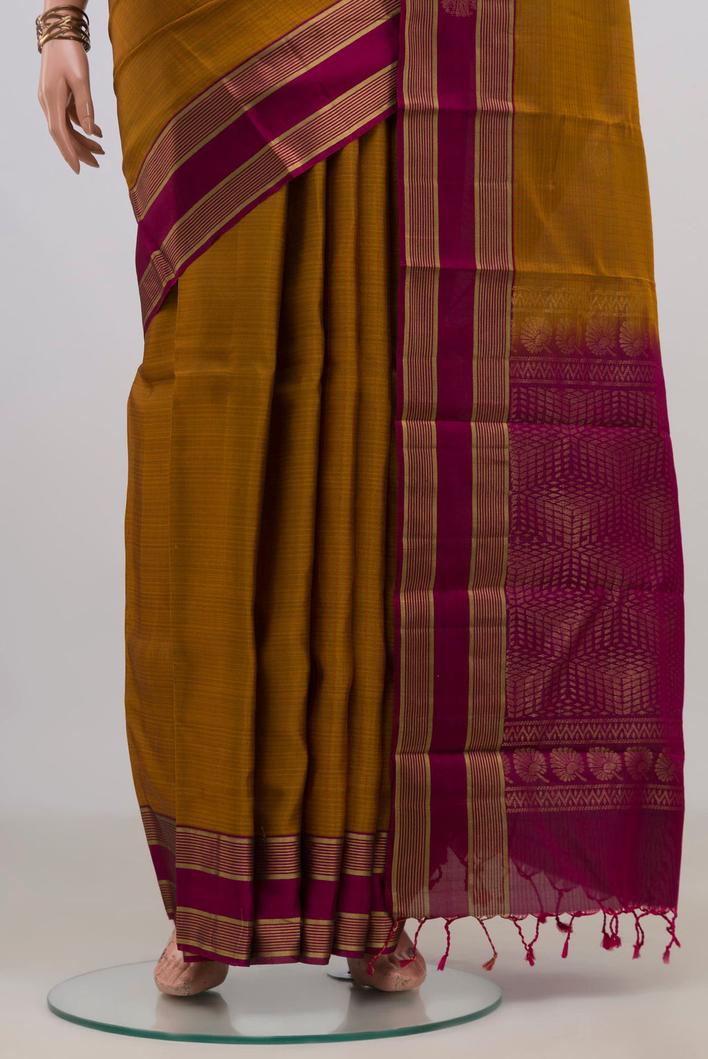 Pleats and pallu of Pure Silk Mustard Soft Saree with Zari Butta on the body and Fancy Border. 