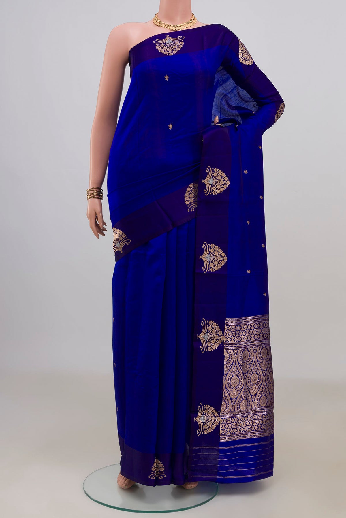 Pure Silk Royal Blue Banarasi Katan Saree with Zari Butta on the body and Fancy Border.  displayed on a mannequin