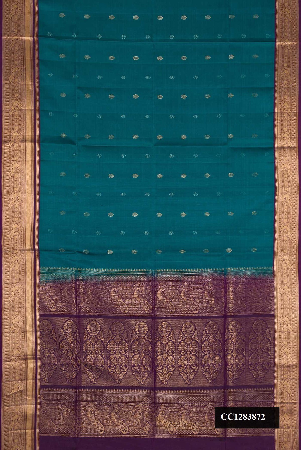Peacock Blue Dual Tone Soft Silk Saree with Zari Butta on the body and Zari Border.  displayed on a mannequin