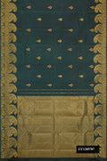 Green Dual Tone Kanchipuram Silk Saree with Zari And Thread Butta on the body and Zari Border.  displayed on a mannequin