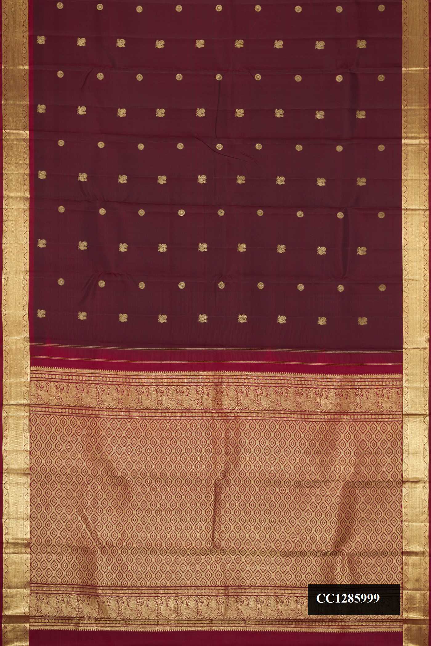 Maroon Dual Tone Kanchipuram Silk Saree with Zari Butta on the body and Zari Border.  displayed on a mannequin