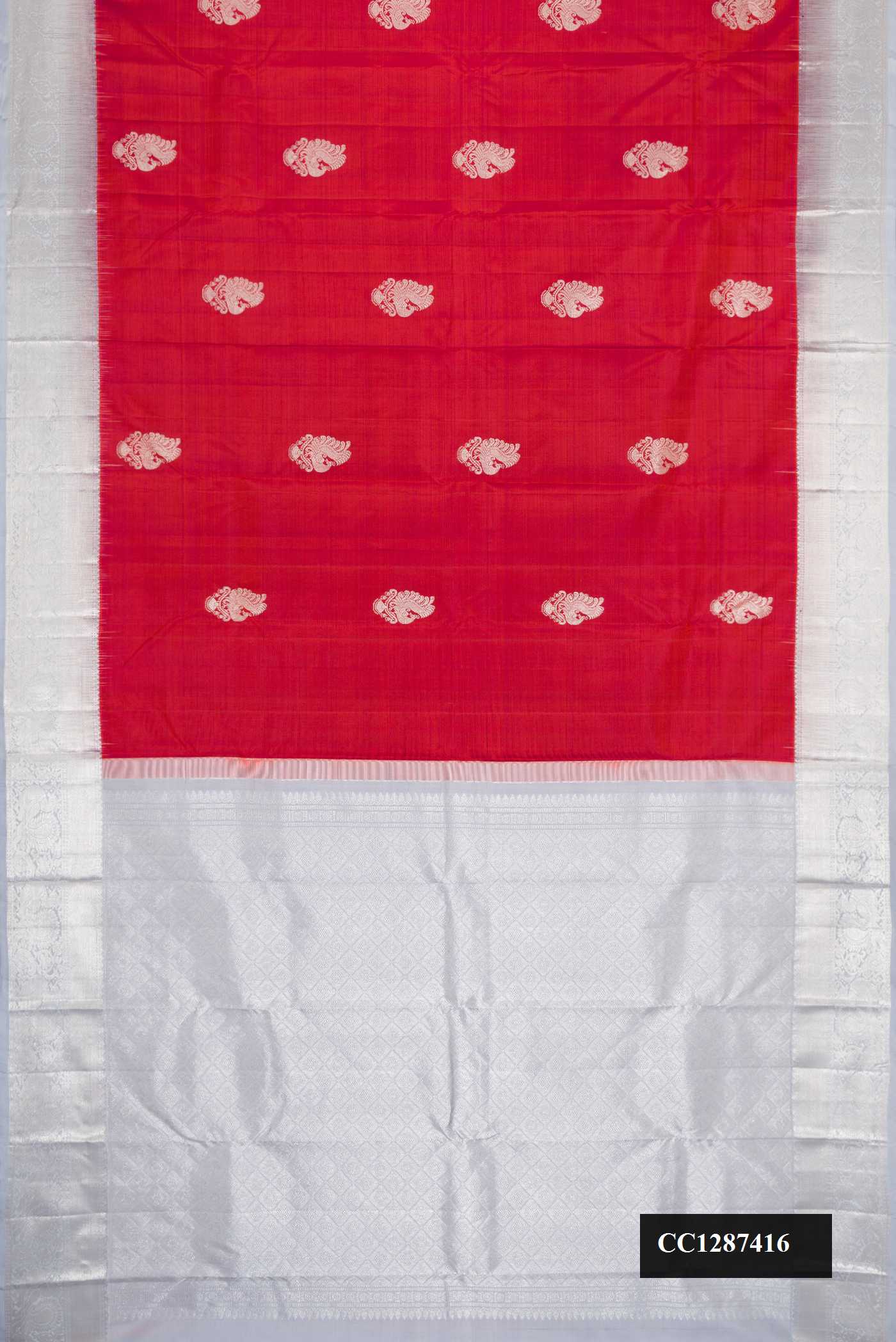 Brick Orange Dual Tone Kanchipuram Silk Saree with Zari Butta on the body and Zari Border.  displayed on a mannequin