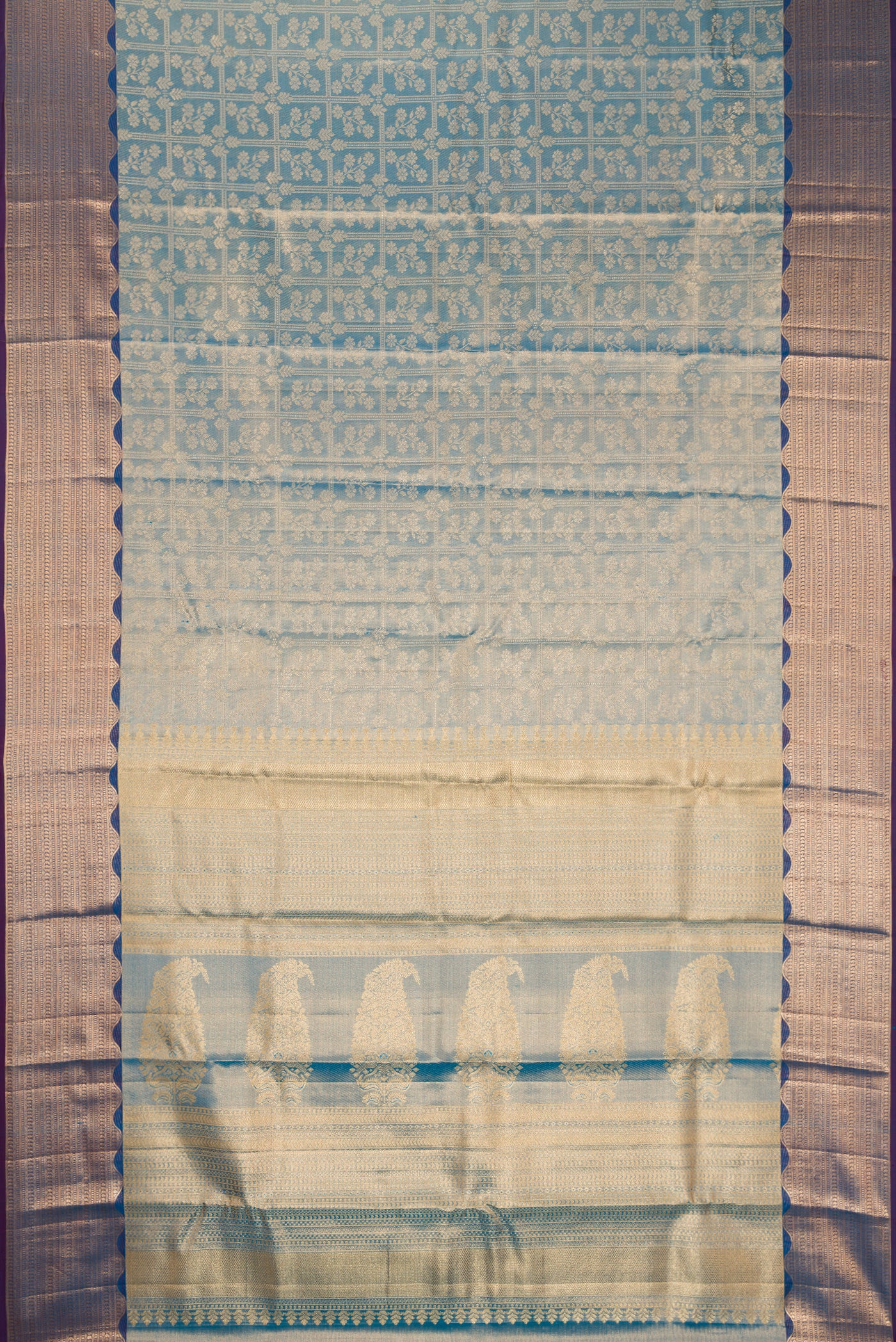 Peacock Blue Dual Tone Kanchipuram Tissue Silk Saree with Zari Brocade on the body and Fancy Border.  displayed on a mannequin