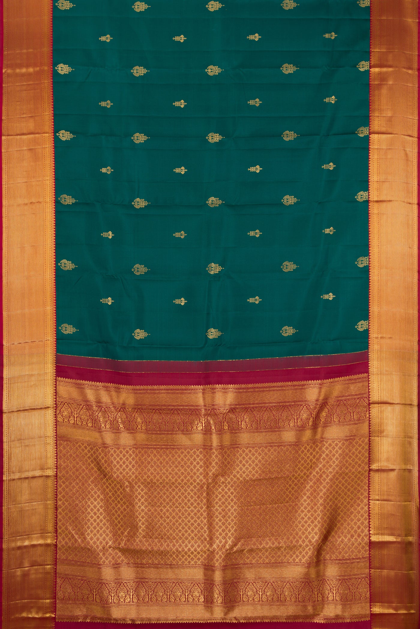 Bottle Green Dual Tone Kanchipuram Silk Saree with Zari Butta on the body and Zari Border.  displayed on a mannequin