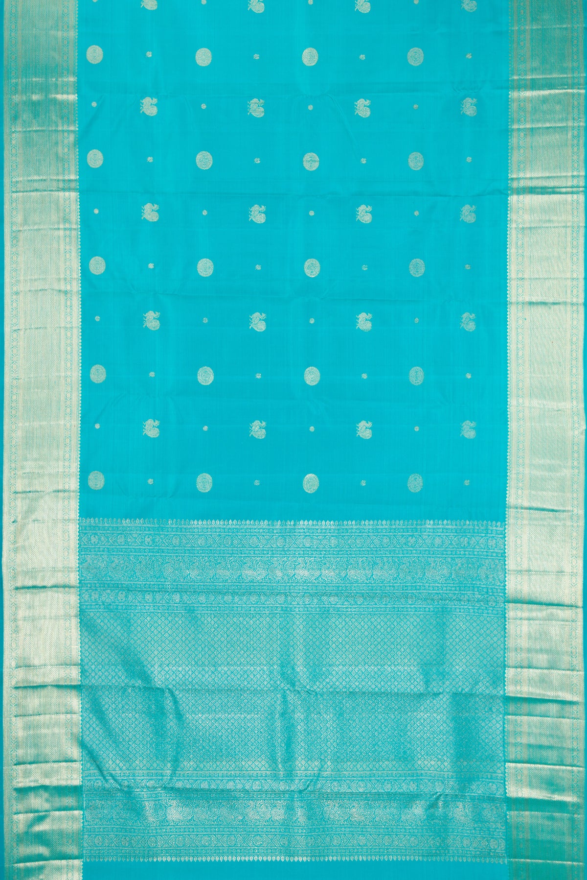 Sky Blue Dual Tone Kanchipuram Silk Saree with Zari Butta on the body and Zari Border.  displayed on a mannequin