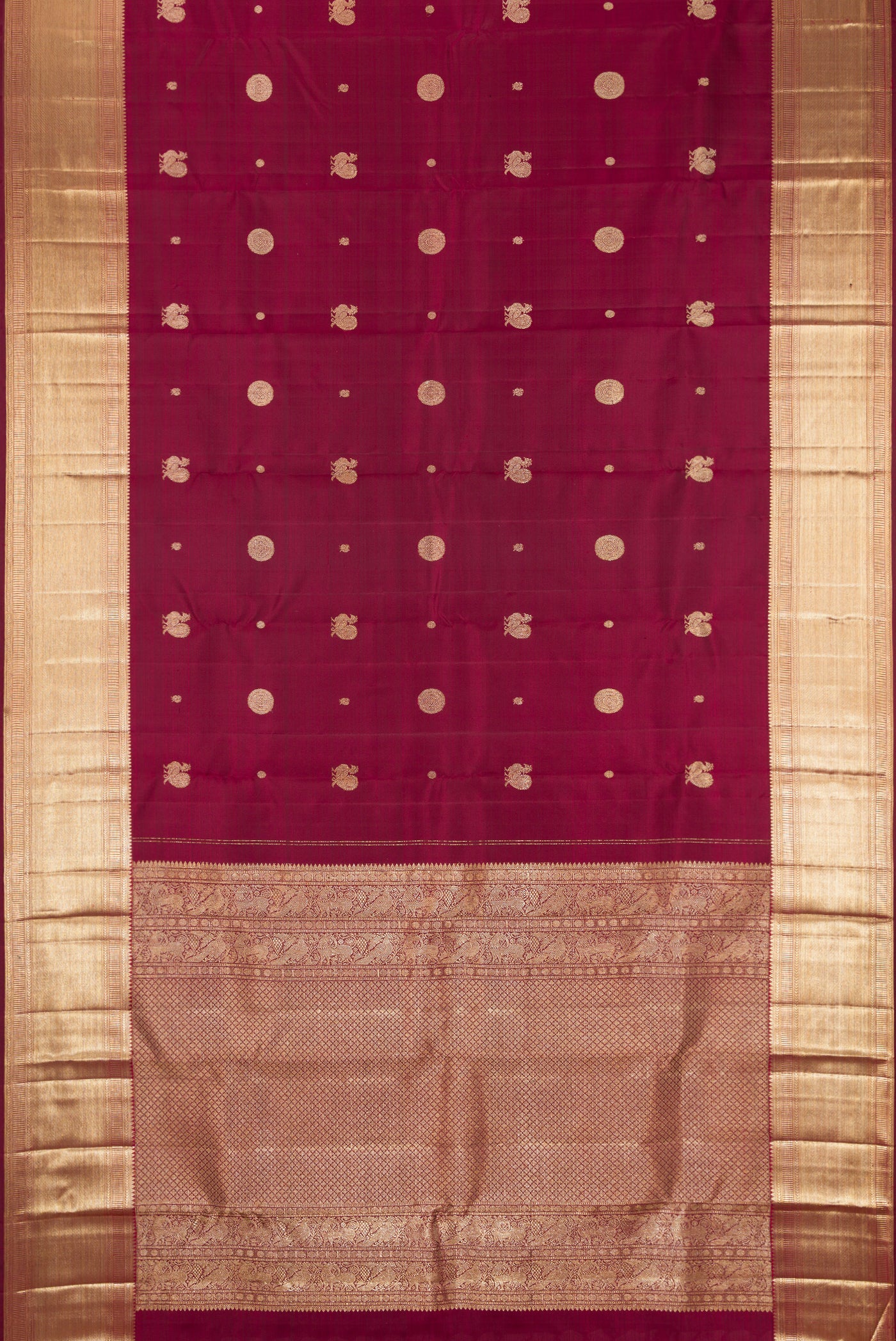 Maroon Dual Tone Kanchipuram Silk Saree with Zari Butta on the body and Zari Border.  displayed on a mannequin