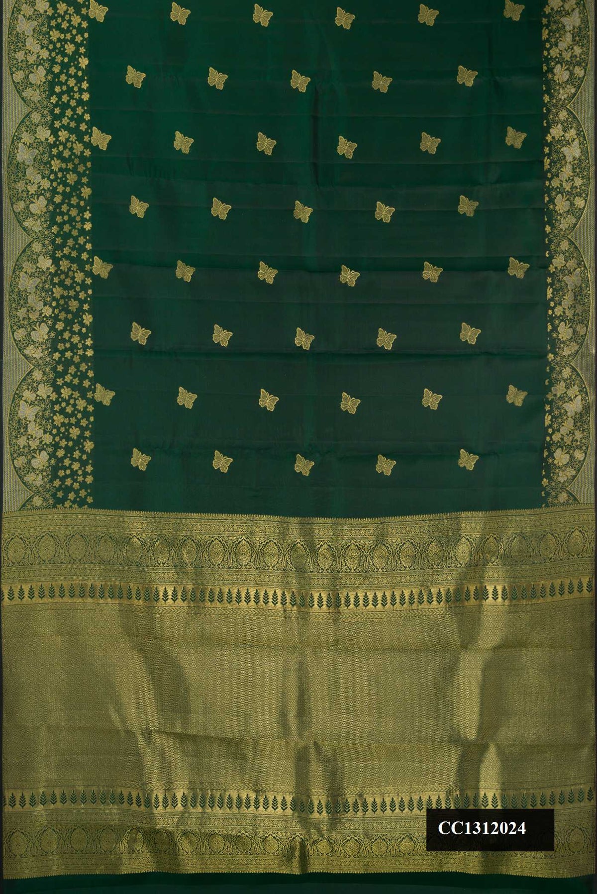 Bottle Green Dual Tone Kanchipuram Silk Saree with Zari Butta on the body and Fancy Border.  displayed on a mannequin