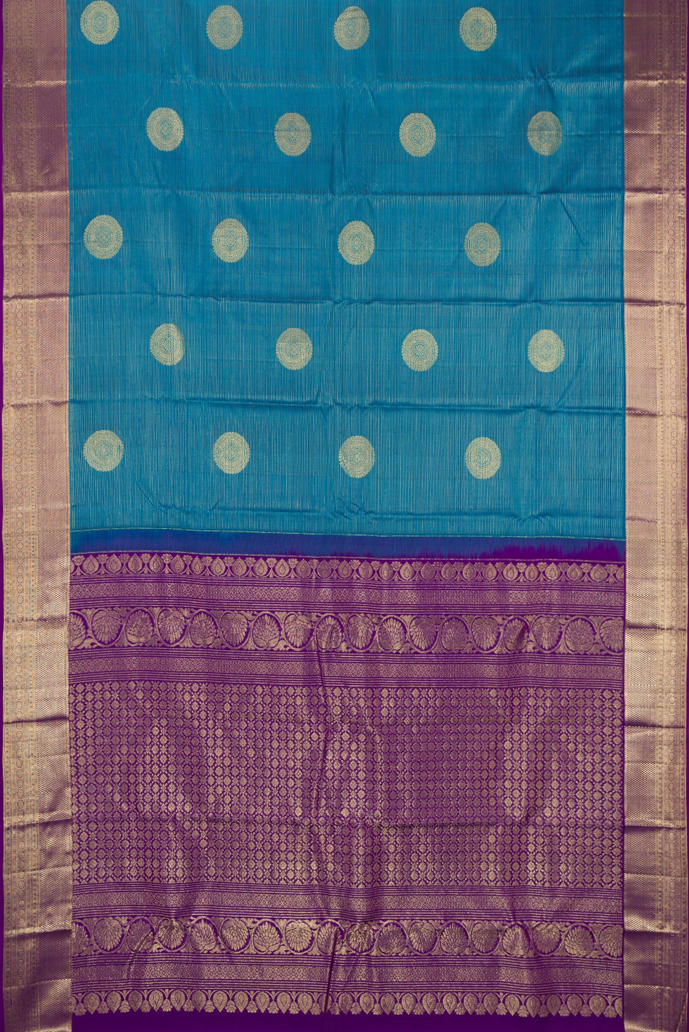 Peacock Blue Dual Tone Kanchipuram Silk Saree with Stripes on the body and Zari Border.  displayed on a mannequin