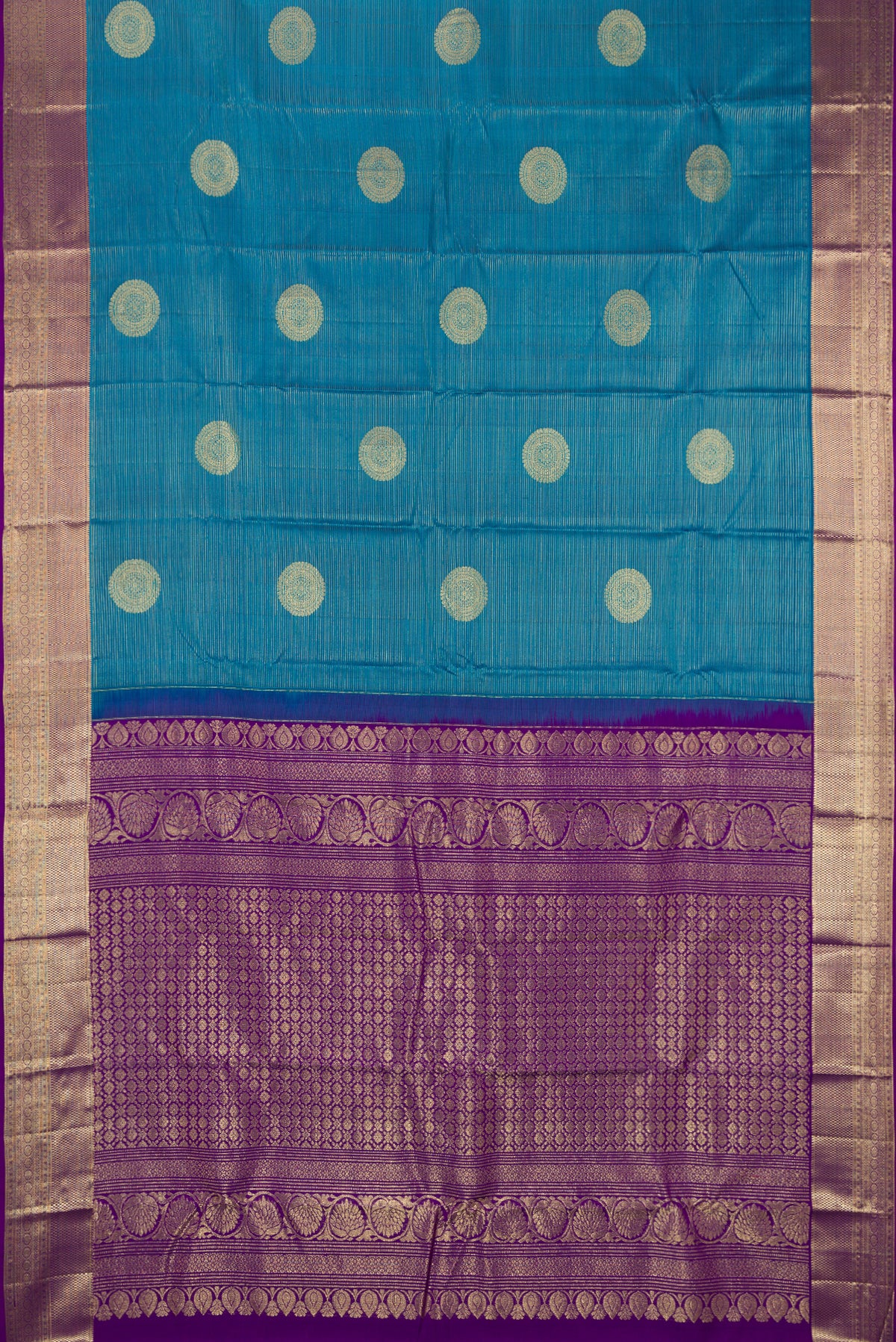 Peacock Blue Dual Tone Kanchipuram Silk Saree with Stripes on the body and Zari Border.  displayed on a mannequin