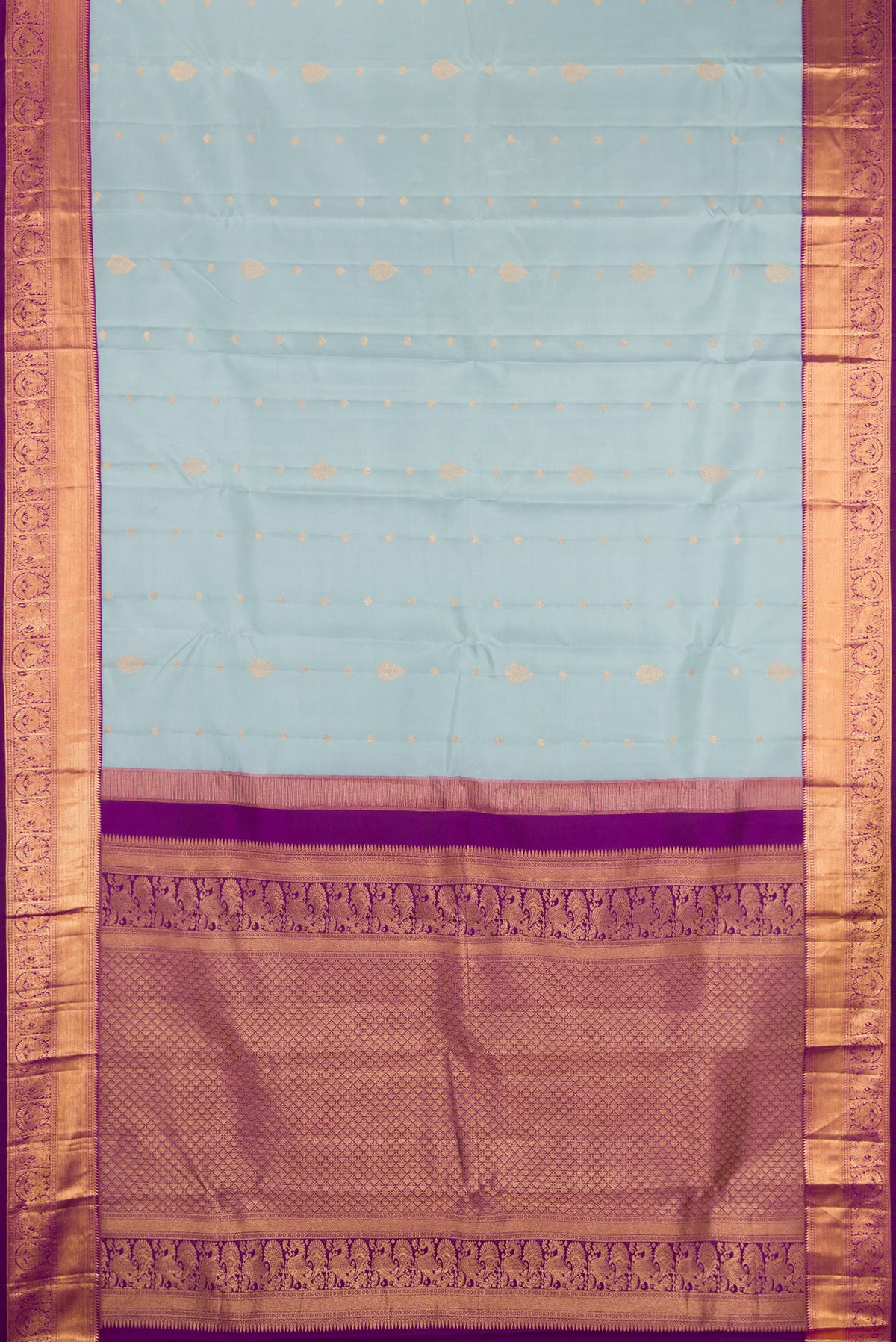 Light Blue Dual Tone Kanchipuram Silk Saree with Zari Butta on the body and Zari Border.  displayed on a mannequin