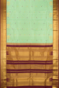 Pista Green Dual Tone Kanchipuram Silk Saree with Zari And Thread Butta on the body and Zari Border.  displayed on a mannequin