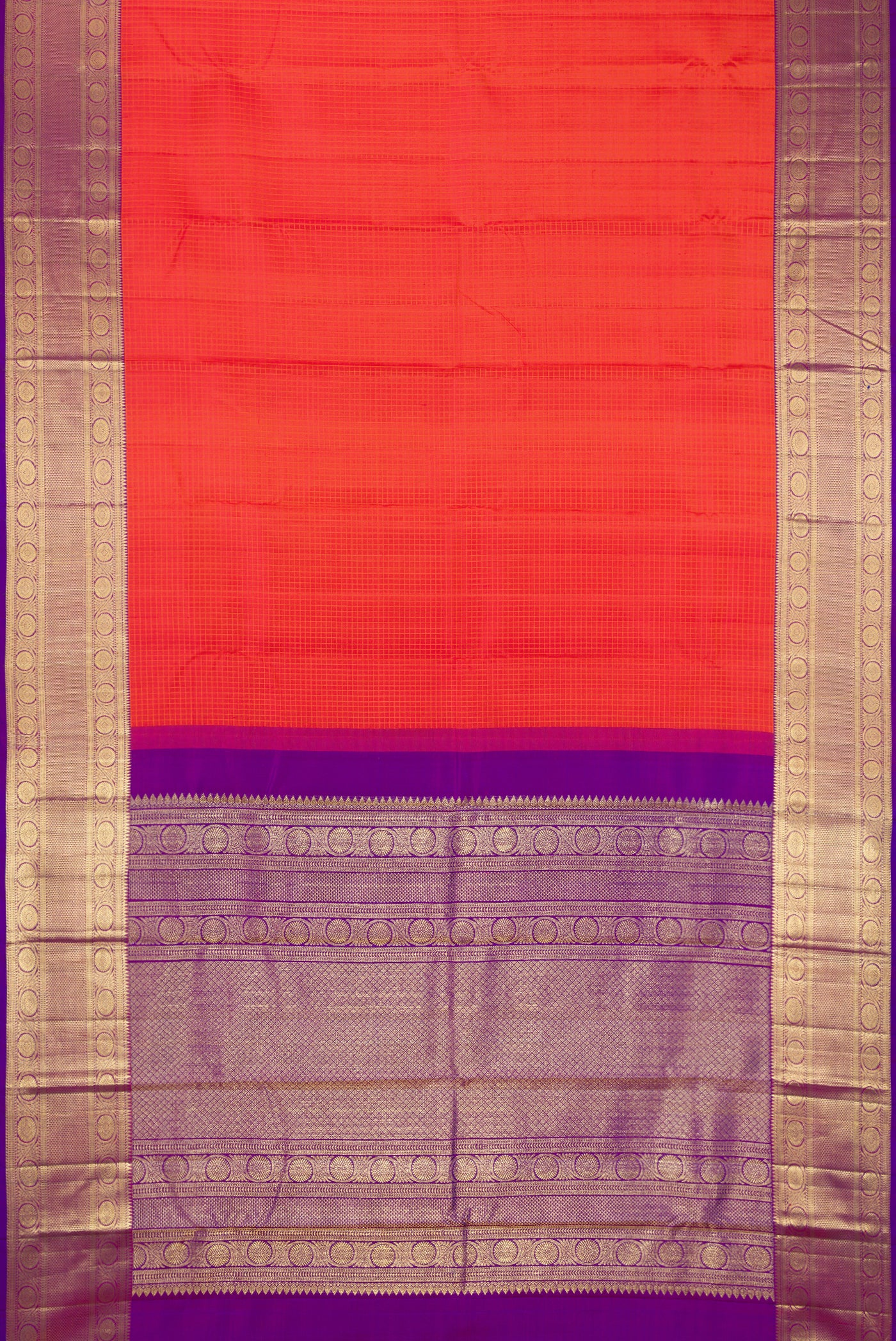 Brick Orange Dual Tone Kanchipuram Silk Saree with Checked design on the body and Fancy Border.  displayed on a mannequin