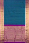 Peacock Blue Dual Tone Kanchipuram Silk Saree with Checked design on the body and Fancy Border.  displayed on a mannequin