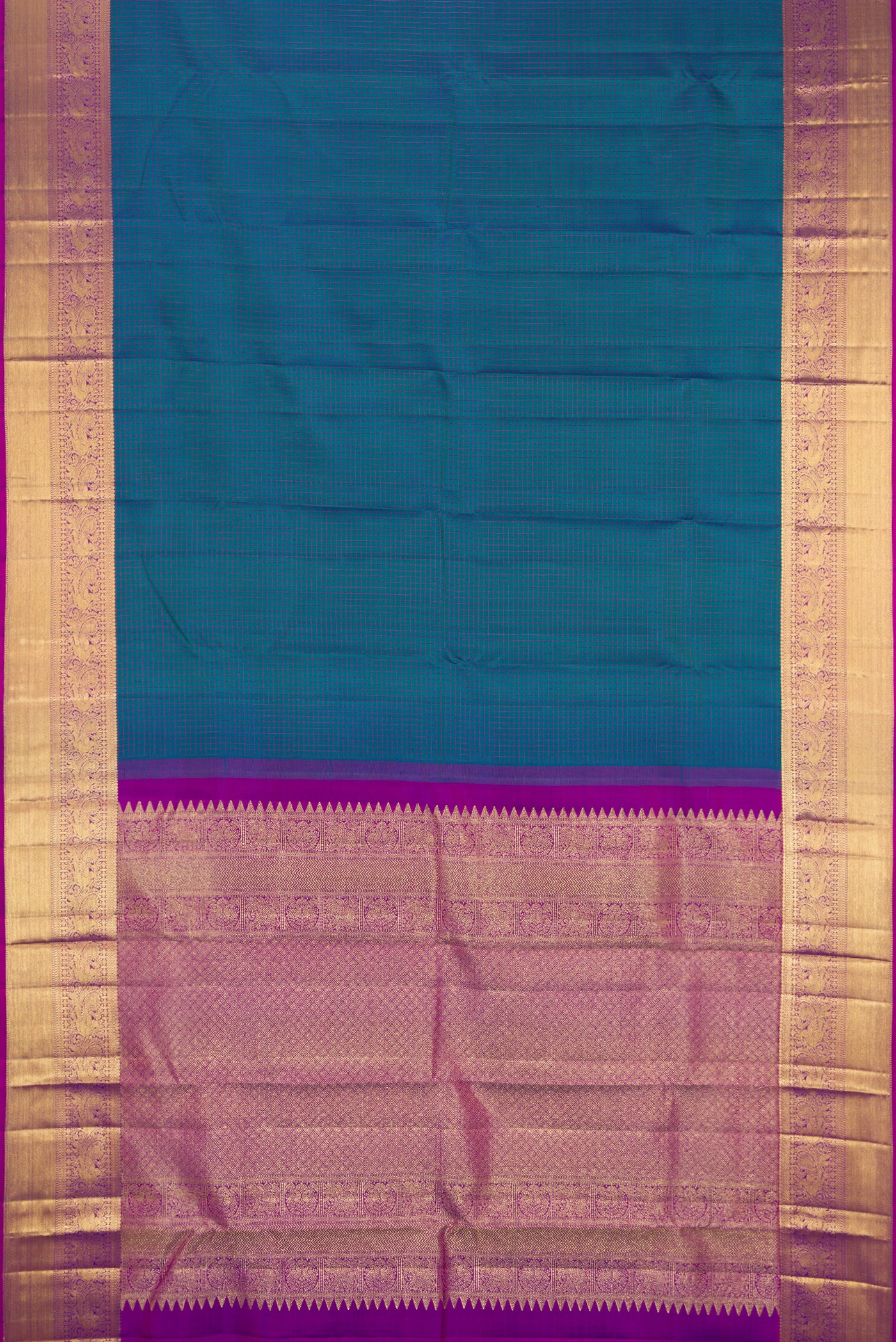 Peacock Blue Dual Tone Kanchipuram Silk Saree with Checked design on the body and Fancy Border.  displayed on a mannequin