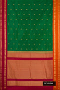 Bottle Green Dual Tone Kanchipuram Silk Saree with Zari Butta on the body and Ganga Jamuna Border.  displayed on a mannequin