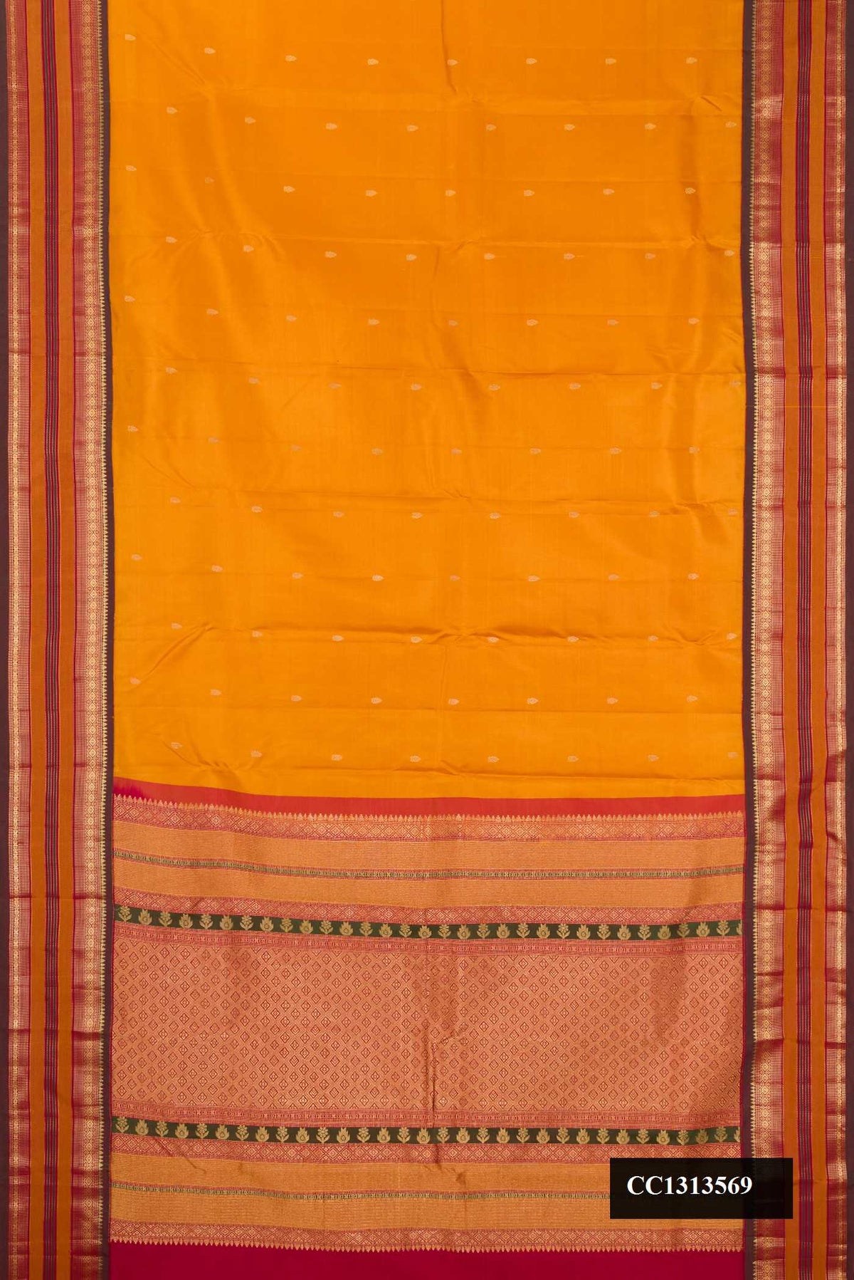 Mustard Dual Tone Kanchipuram Silk Saree with Zari Butta on the body and Fancy Border.  displayed on a mannequin
