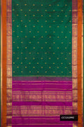 Bottle Green Dual Tone Kanchipuram Silk Saree with Zari Butta on the body and Fancy Border.  displayed on a mannequin