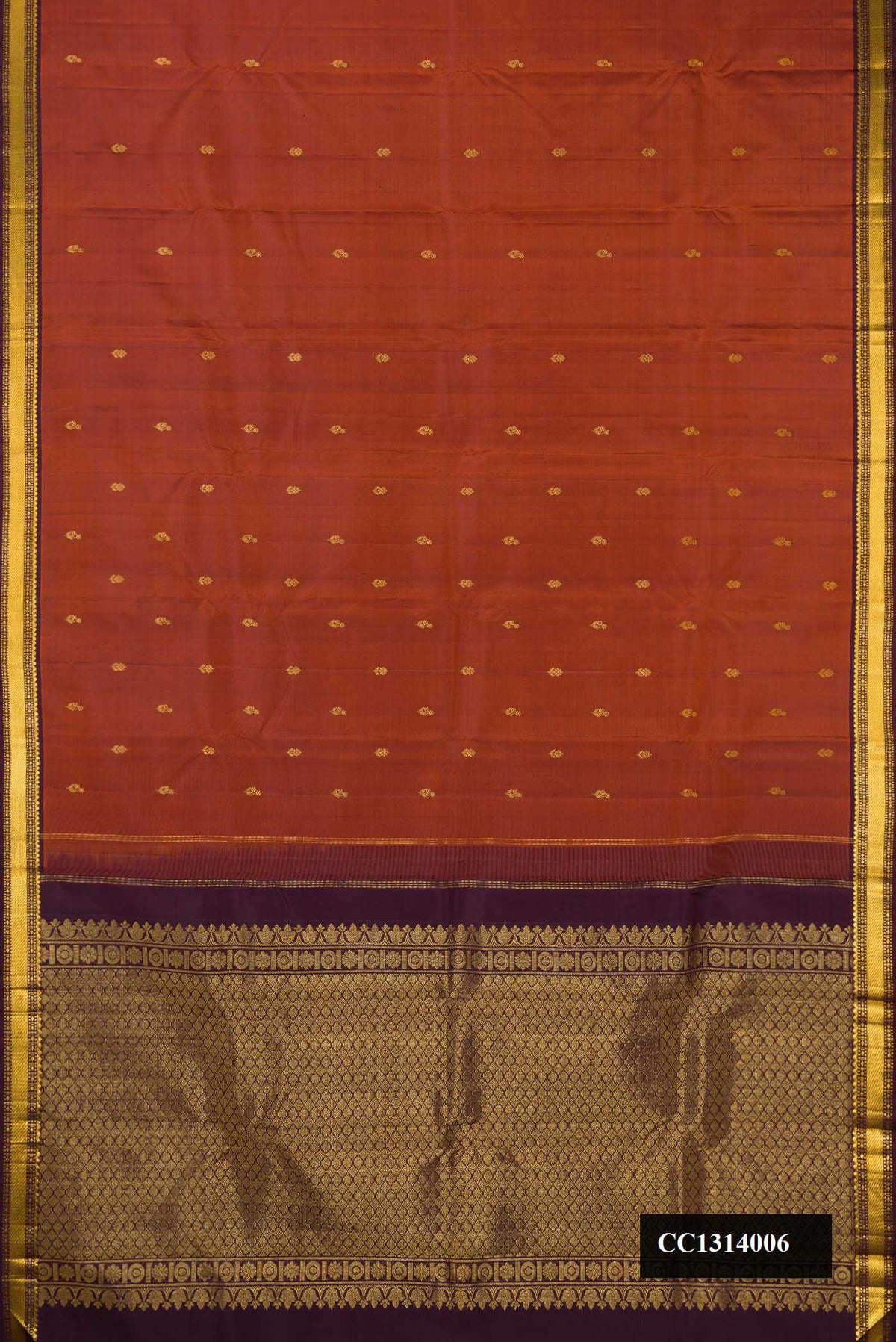 Rust Dual Tone Kanchipuram Silk Saree with Zari Butta on the body and Zari Border.  displayed on a mannequin