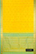 Lemon Yellow Dual Tone Kanchipuram Silk Saree with Zari Butta on the body and Zari Border.  displayed on a mannequin