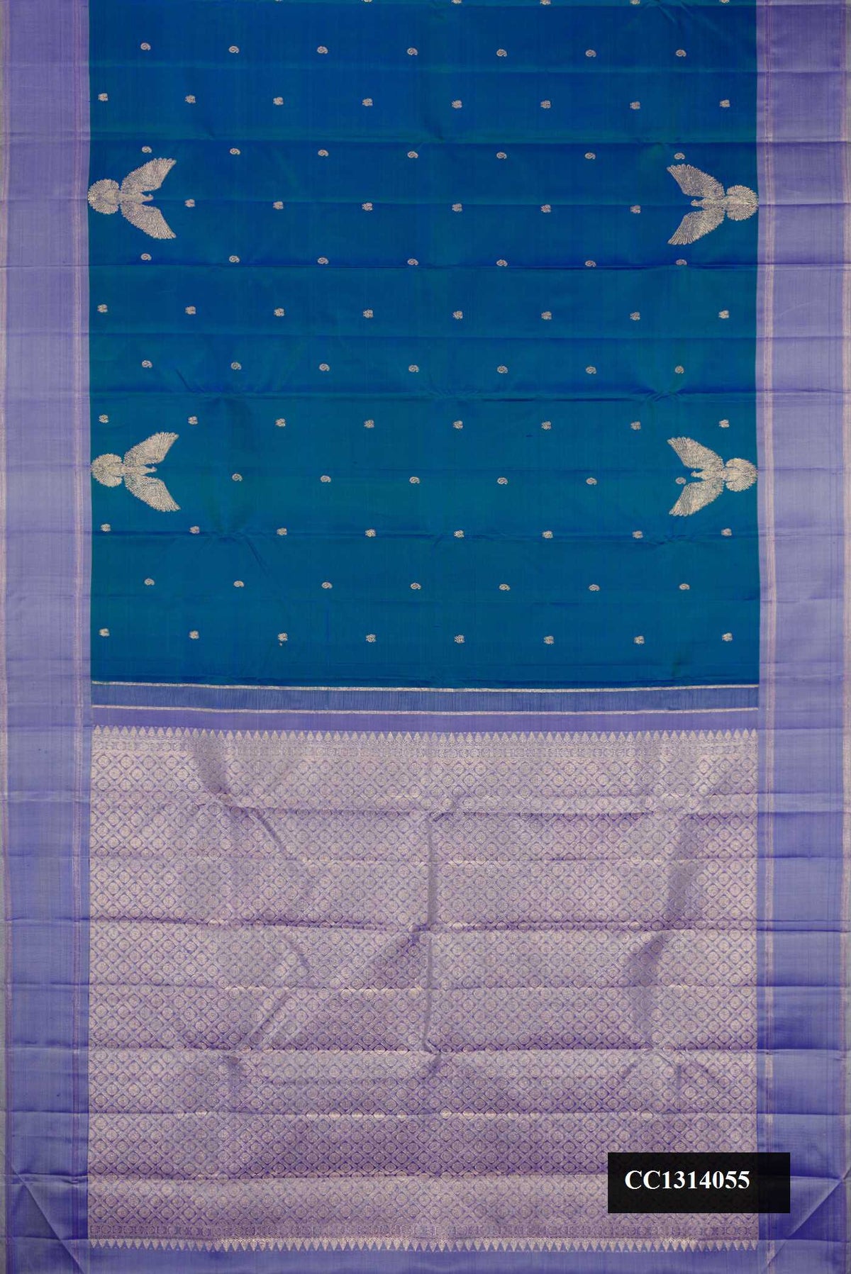 Peacock Blue Dual Tone Kanchipuram Silk Saree with Zari Butta on the body and Fancy Border.  displayed on a mannequin