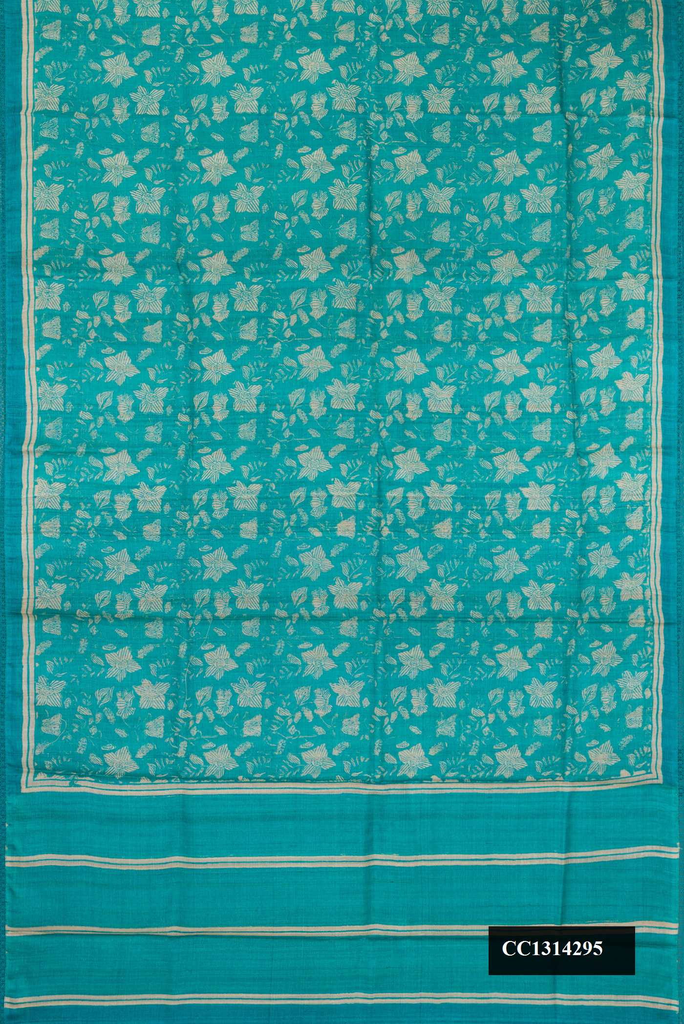 Sky Blue Dual Tone Tussar Silk Saree with Printed design on the body and Embroidery Border.  displayed on a mannequin