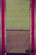 Green Dual Tone Kanchipuram Silk Saree with Zari Butta on the body and Zari Border.  displayed on a mannequin