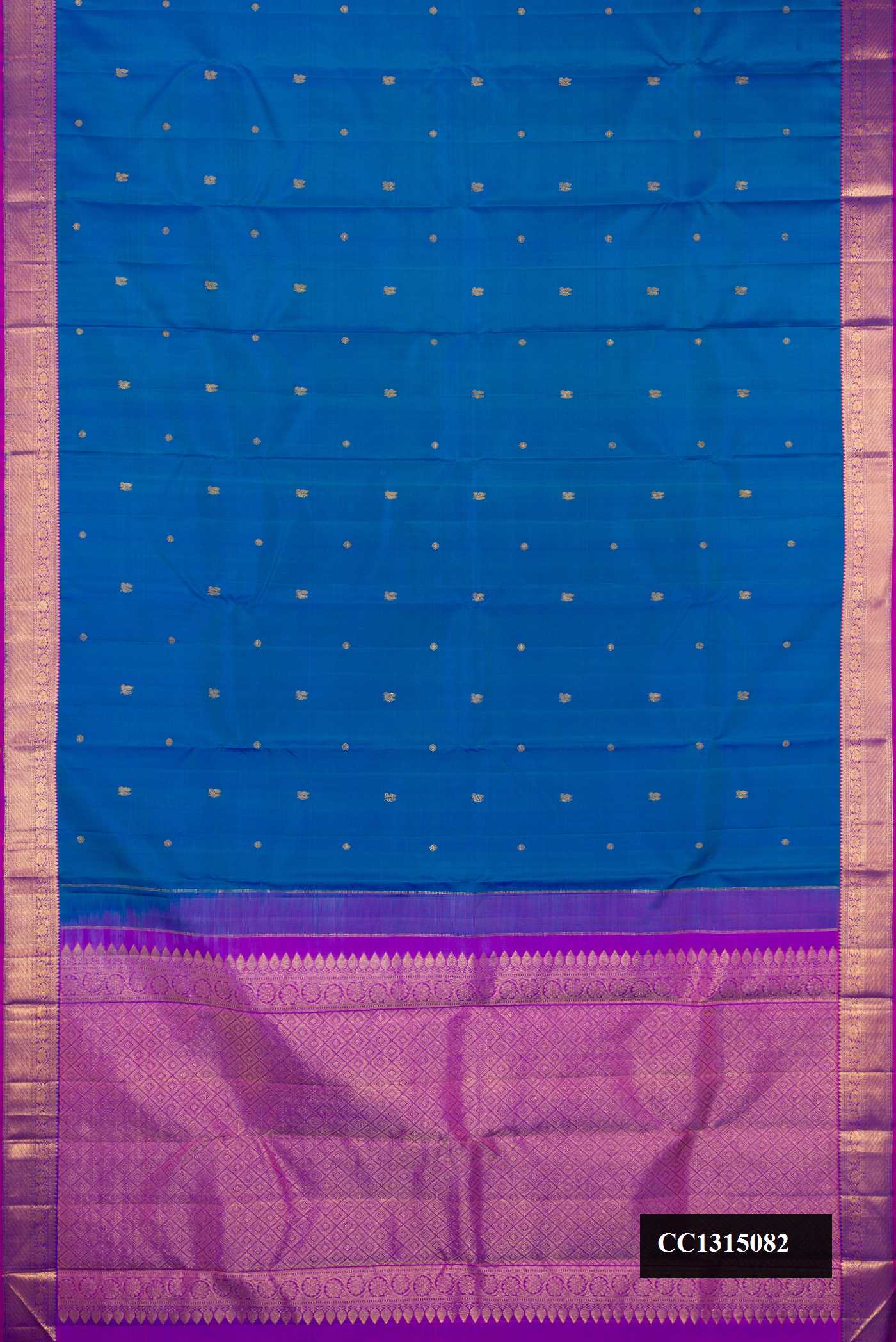 Peacock Blue Dual Tone Kanchipuram Silk Saree with Zari Butta on the body and Zari Border.  displayed on a mannequin