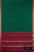 Bottle Green Dual Tone Kanchipuram Silk Saree with Stripes on the body and Zari Border.  displayed on a mannequin