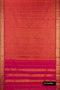 Rust Dual Tone Kanchipuram Silk Saree with Stripes on the body and Zari Border.  displayed on a mannequin