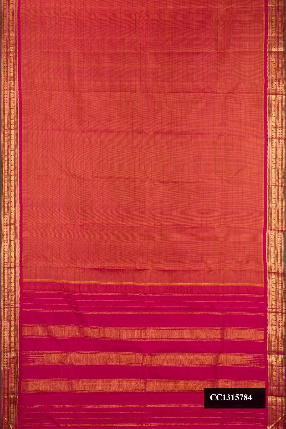 Rust Dual Tone Kanchipuram Silk Saree with Stripes on the body and Zari Border.  displayed on a mannequin