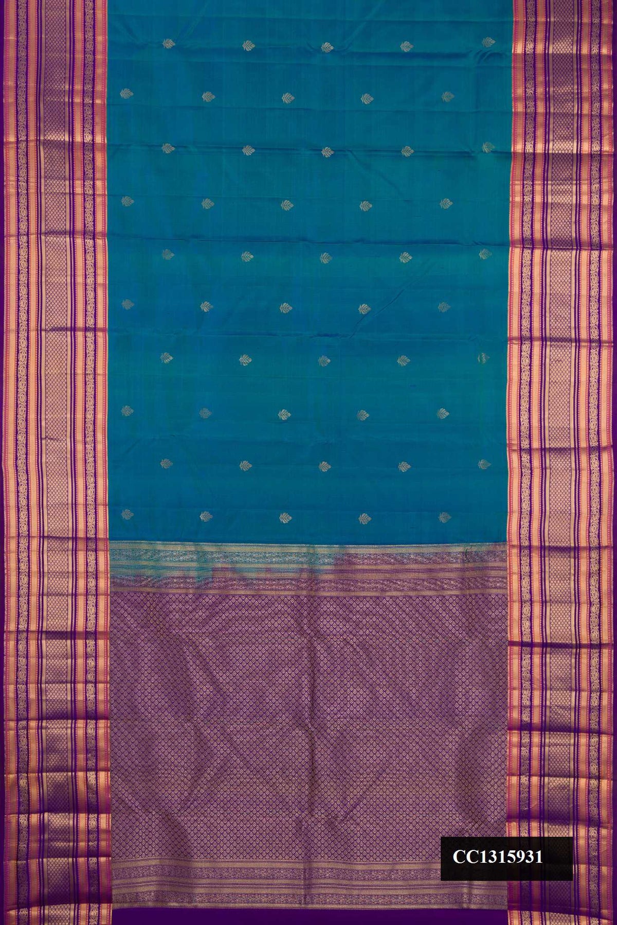 Peacock Blue Dual Tone Kanchipuram Silk Saree with Zari Butta on the body and Fancy Border.  displayed on a mannequin